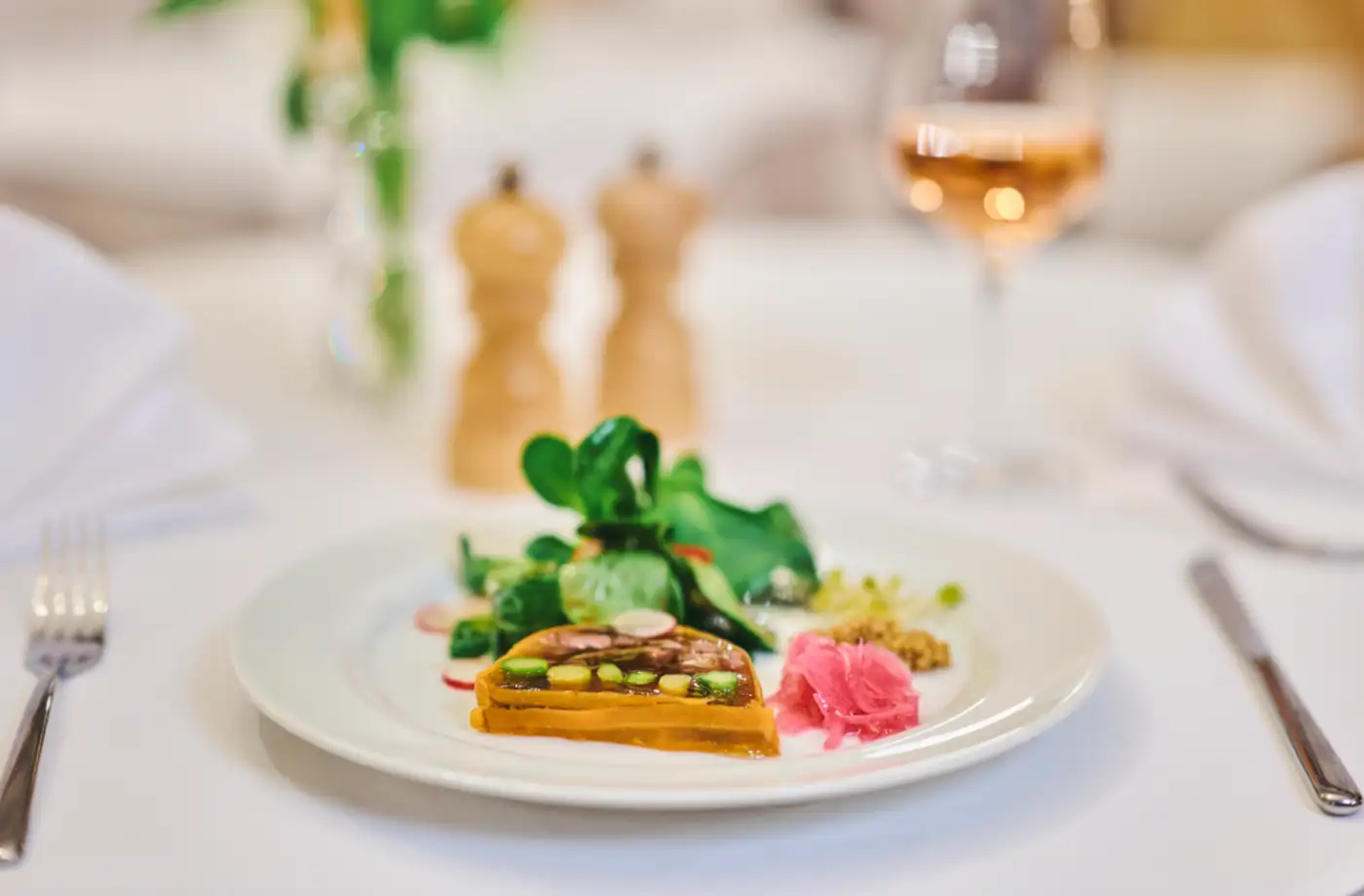 Ein Teller mit exquisitem Gericht im Restaurant, präsentiert mit frischem Salat und buntem Gemüse, ideal für Feinschmecker.