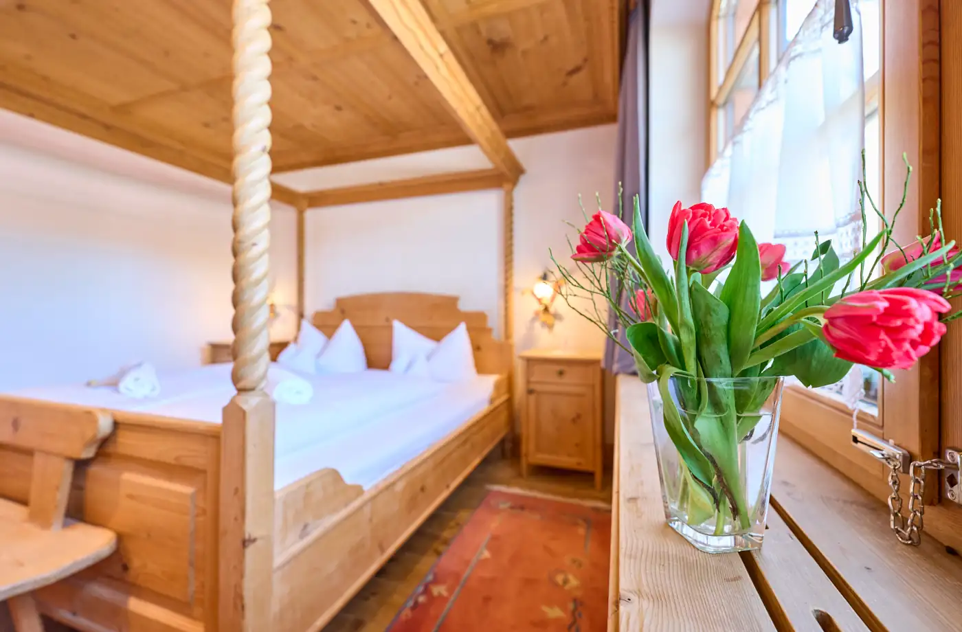 Traditionelles Doppelzimmer im Hintergrund mit roten Tulpen im Vordergrund