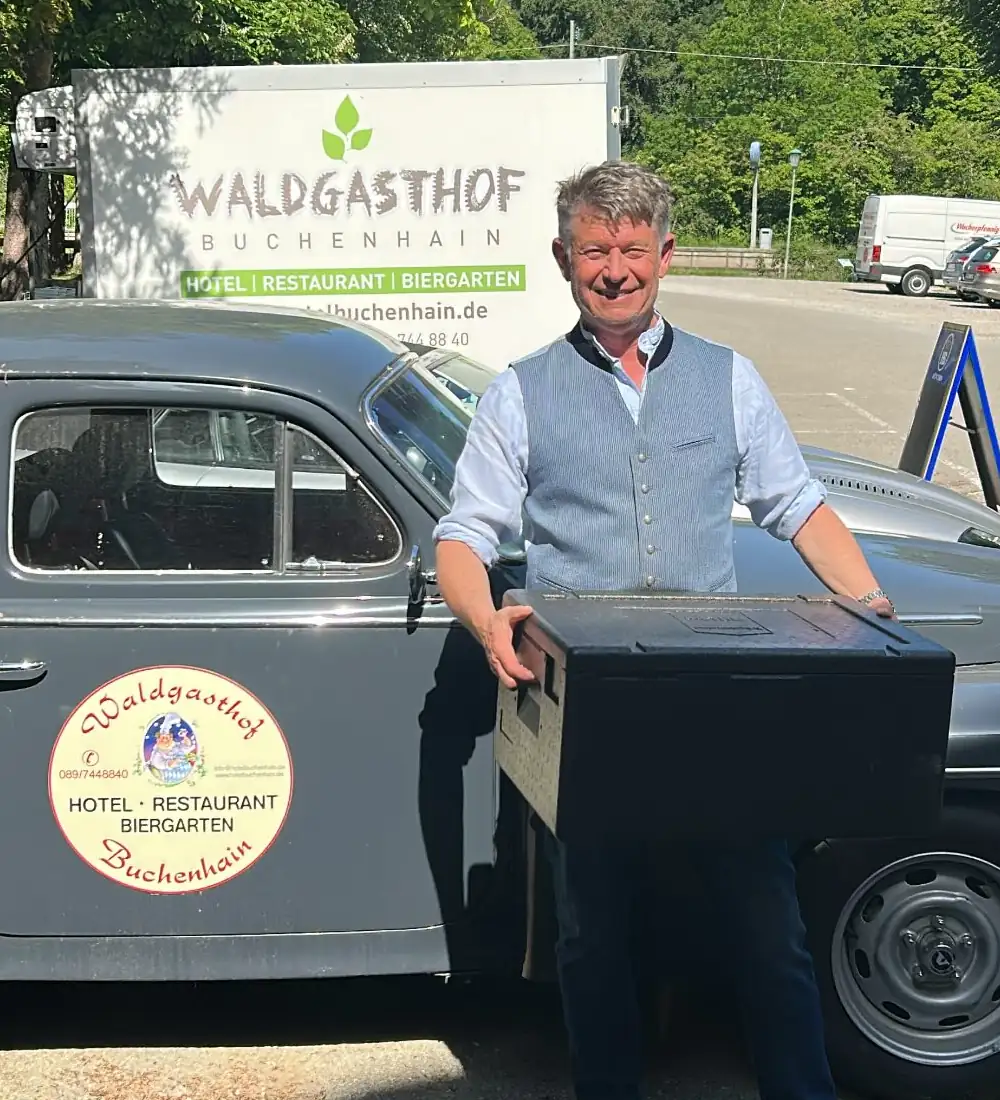 Gastgeber des Waldgasthof Buchenhain zeigt eine Lieferung vor dem Hotel und Restaurant in der schönen Natur.